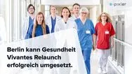 Sieben medizinische Fachkräfte in weißer und bunter Arbeitskleidung gehen freundlich einen Krankenhausflur entlang